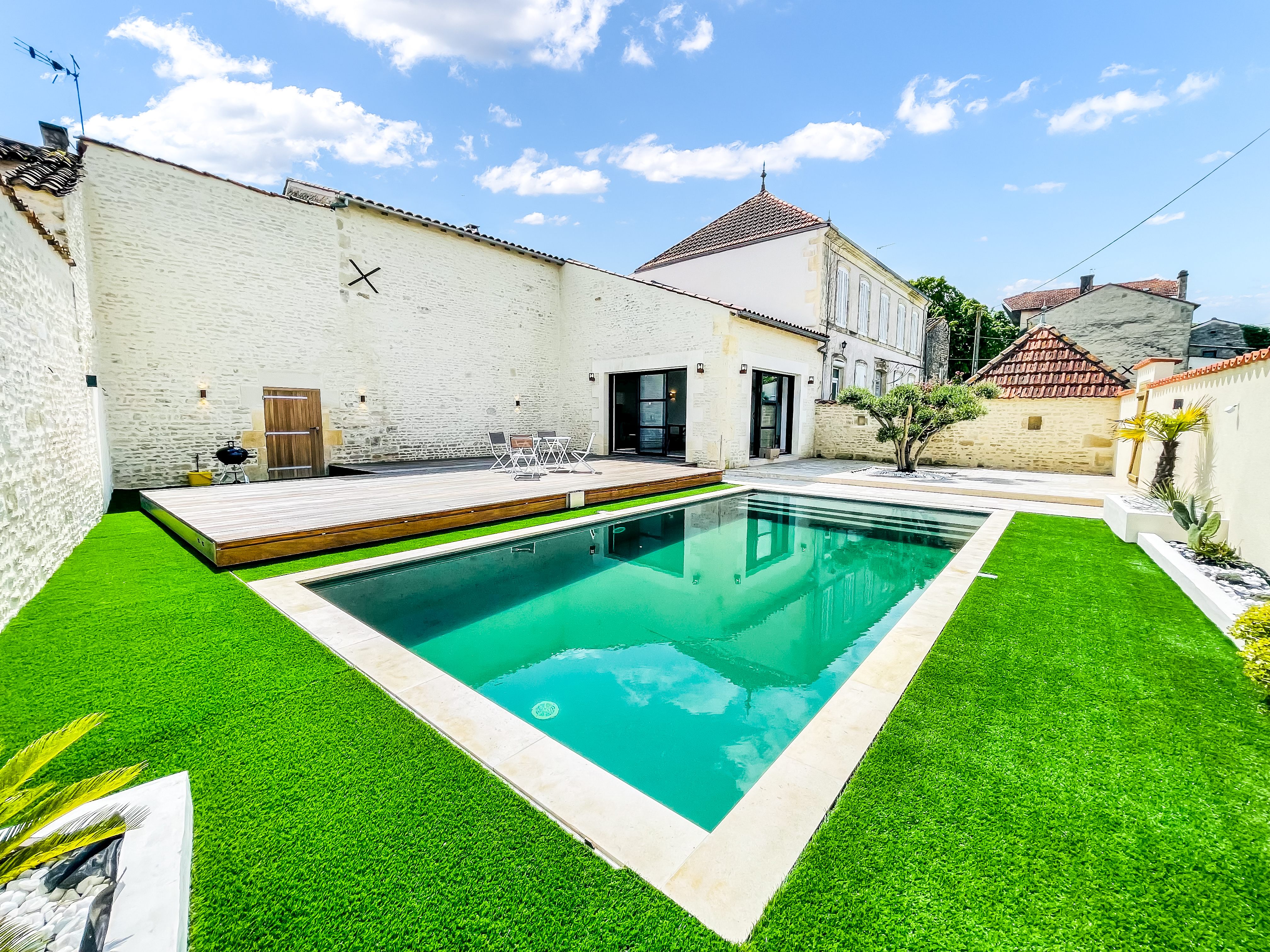 Swimming pool with stone walls and blue sky